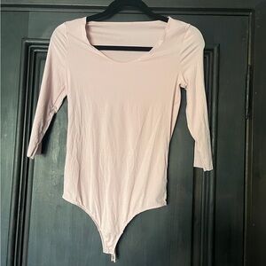 Nude bodysuit small holes where tag was removed behind neck